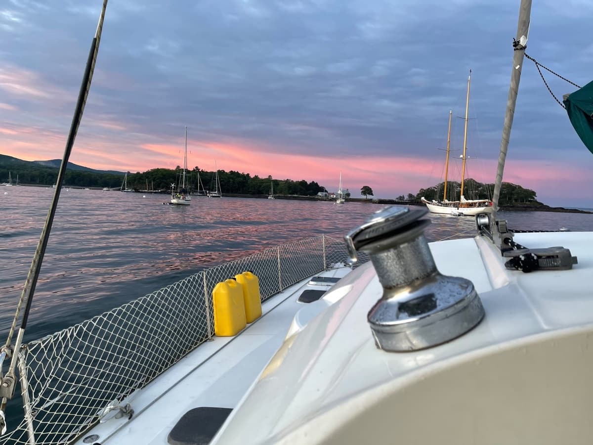 Dusk over a harbor of moored boats, seen from the deck